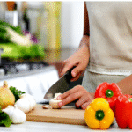 Cook chopping fresh vegetables for meal preparation in kitchen